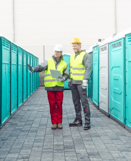 Workers Checking The Portable Toilets For Rental